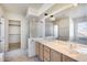 Open bathroom with a large vanity, a glass shower, and a view outside the window at 4001 E Rosemonte Dr, Phoenix, AZ 85050