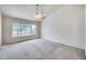 Open bedroom has a ceiling fan, a neutral carpet, and a big window with view outside at 4001 E Rosemonte Dr, Phoenix, AZ 85050