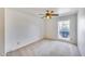 Bright bedroom with neutral carpet, ceiling fan, and natural light from a window at 4001 E Rosemonte Dr, Phoenix, AZ 85050
