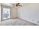 Bedroom with carpet, ceiling fan, and a large window offering natural light at 4001 E Rosemonte Dr, Phoenix, AZ 85050