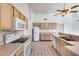 Functional kitchen features white appliances, neutral countertops, and wood cabinets at 4001 E Rosemonte Dr, Phoenix, AZ 85050
