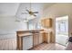 Open kitchen featuring light wood cabinets and stainless steel sink with tile flooring at 4001 E Rosemonte Dr, Phoenix, AZ 85050