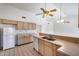 Well-lit kitchen area features white appliances, neutral countertops, and wood cabinets at 4001 E Rosemonte Dr, Phoenix, AZ 85050