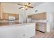 Kitchen with breakfast bar, light wood cabinets, and white appliances at 4001 E Rosemonte Dr, Phoenix, AZ 85050