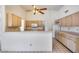 Kitchen with light wood cabinets, white appliances, breakfast bar and tile flooring at 4001 E Rosemonte Dr, Phoenix, AZ 85050