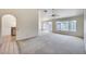 Spacious living room with neutral carpet, ceiling fan, chandelier, and lots of natural light at 4001 E Rosemonte Dr, Phoenix, AZ 85050