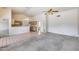Spacious living room with open kitchen, tile floor, carpet, and ceiling fans at 4001 E Rosemonte Dr, Phoenix, AZ 85050