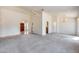 Open living area with carpet flooring and natural light, flowing into the entryway and kitchen at 4001 E Rosemonte Dr, Phoenix, AZ 85050