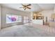 Bright living room with large windows, tile, carpet flooring, and open kitchen access at 4001 E Rosemonte Dr, Phoenix, AZ 85050