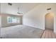 Bright living room with neutral carpet, ceiling fan, vaulted ceiling, and large windows at 4001 E Rosemonte Dr, Phoenix, AZ 85050