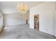 Open living area with carpet flooring and natural light, flowing into the entryway and kitchen at 4001 E Rosemonte Dr, Phoenix, AZ 85050