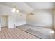 Open living room with tile and carpet flooring, vaulted ceiling, and ceiling fan at 4001 E Rosemonte Dr, Phoenix, AZ 85050