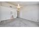 Main bedroom with bathroom access, bright carpet, and a modern ceiling fan at 4001 E Rosemonte Dr, Phoenix, AZ 85050
