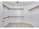 Walk-in closet with shelving units around the perimeter for organized storage space at 4001 E Rosemonte Dr, Phoenix, AZ 85050