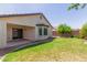 Well-maintained backyard featuring a covered patio, nice green lawn, and corner windows at 4094 E Los Altos Dr, Gilbert, AZ 85297
