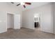 Bedroom with a ceiling fan, ensuite bathroom, and neutral decor at 4094 E Los Altos Dr, Gilbert, AZ 85297