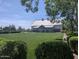 Exterior view of a building surrounded by a green lawn and beautiful landscaping at 4094 E Los Altos Dr, Gilbert, AZ 85297