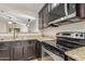 Kitchen showcasing stainless steel appliances, granite countertops, and dark wood cabinetry at 4094 E Los Altos Dr, Gilbert, AZ 85297