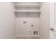 Bright laundry room featuring tile flooring, shelving, and laundry connections at 4094 E Los Altos Dr, Gilbert, AZ 85297