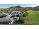 Breathtaking aerial view of a luxury home with a pool, modern design, and stunning mountain backdrop at 4098 N Golf Dr, Buckeye, AZ 85396