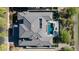 Aerial view of a well-manicured property featuring a large rectangular pool, desert landscaping, and a gray tiled roof at 4098 N Golf Dr, Buckeye, AZ 85396