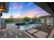 A luxury backyard features a pool, spa, desert landscaping, and mountain views at 4098 N Golf Dr, Buckeye, AZ 85396
