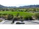 Picturesque view from the backyard overlooking a lush golf course and scenic mountains on a sunny day at 4098 N Golf Dr, Buckeye, AZ 85396