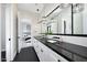 Modern bathroom with dual sinks, luxurious lighting and a view to the bedroom at 4098 N Golf Dr, Buckeye, AZ 85396