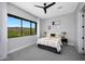 Bright bedroom with large picture window showcasing picturesque desert landscape at 4098 N Golf Dr, Buckeye, AZ 85396
