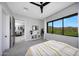 Cozy bedroom with natural light, an ensuite and scenic landscape views at 4098 N Golf Dr, Buckeye, AZ 85396