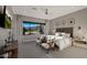 Serene main bedroom featuring a view of the mountains, accent chairs and neutral tones at 4098 N Golf Dr, Buckeye, AZ 85396