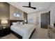 Modern bedroom featuring a ceiling fan, neutral walls, and an open doorway to the bathroom at 4098 N Golf Dr, Buckeye, AZ 85396