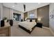 Modern bedroom with a ceiling fan, patterned accent wall and a window with a view at 4098 N Golf Dr, Buckeye, AZ 85396