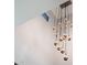 Unique chandelier hanging from a high ceiling, adding modern art to the room at 4098 N Golf Dr, Buckeye, AZ 85396