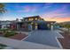 Beautiful home boasts a contemporary design, three-car garage, attractive curb appeal, and well-maintained landscaping at 4098 N Golf Dr, Buckeye, AZ 85396
