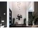 Inviting foyer with high ceilings, modern lighting, and decorative plants and seating at 4098 N Golf Dr, Buckeye, AZ 85396