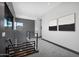 Upstairs hallway with gray walls and carpet, modern railing, and an open view to the outside at 4098 N Golf Dr, Buckeye, AZ 85396