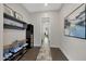 Hallway with decoratively tiled floors, neutral walls, and shelving for storage at 4098 N Golf Dr, Buckeye, AZ 85396