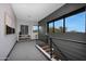 Hallway with gray walls and carpet, modern railing, and lots of natural light from the windows at 4098 N Golf Dr, Buckeye, AZ 85396