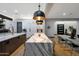 Open kitchen with large island, stainless steel appliances, and dining area at 4098 N Golf Dr, Buckeye, AZ 85396