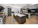 Bright, open kitchen featuring double islands, stainless appliances, custom hood, and hardwood floors at 4098 N Golf Dr, Buckeye, AZ 85396