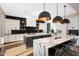 Modern kitchen with double islands, pendant lights, black backsplash, and designer finishes at 4098 N Golf Dr, Buckeye, AZ 85396
