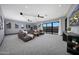 Spacious living room with mountain views, a large sectional sofa, and modern lighting at 4098 N Golf Dr, Buckeye, AZ 85396