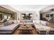 Open-concept living room featuring a large sectional, wood floors, and easy access to the kitchen at 4098 N Golf Dr, Buckeye, AZ 85396