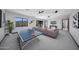 Open-concept living area features a ping pong table and mountain views at 4098 N Golf Dr, Buckeye, AZ 85396