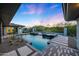 Relaxing poolside featuring a modern pool and spa, desert landscaping, mountain views, and comfortable lounge seating at 4098 N Golf Dr, Buckeye, AZ 85396