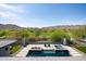 Stunning pool and jacuzzi with mountain views, perfect for outdoor relaxation and entertainment at 4098 N Golf Dr, Buckeye, AZ 85396