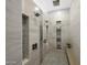 Bright open shower with a dual shower head system and built-in shelving at 4098 N Golf Dr, Buckeye, AZ 85396