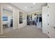 Walk-in closet providing ample storage solutions and an adjacent laundry room at 4098 N Golf Dr, Buckeye, AZ 85396