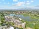 Aerial view of the community, golf course, lake, and residential buildings at 7401 N Scottsdale Rd # 24, Paradise Valley, AZ 85253